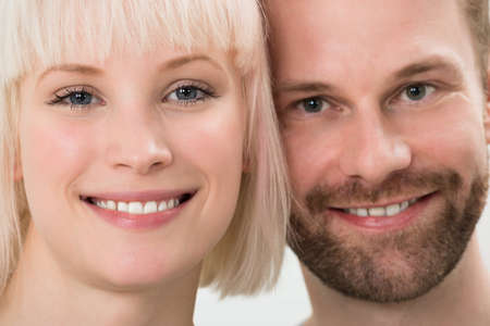 Close-up Photo Of Toothy Smiling Young Coupleの写真素材