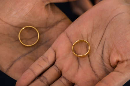 Close-up Of African Hands With Golden Ringsの写真素材