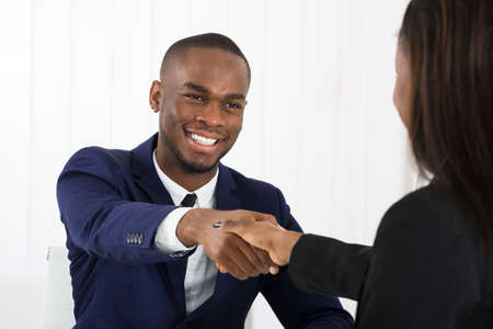 Successful African American Businessman Handshaking With Client In Officeの写真素材