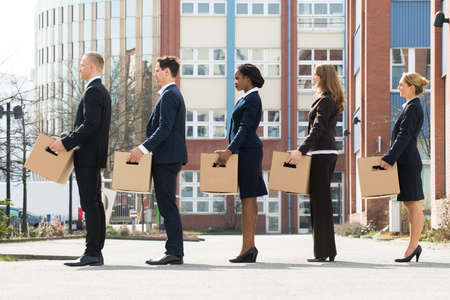 Group Of Multiracial Businesspeople With Cardboard Boxes Standing In A Lineの写真素材