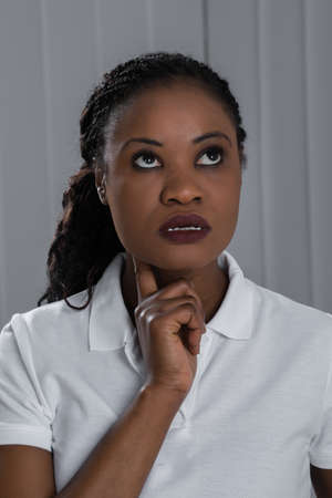 Portrait Of Young Beautiful Woman Thinking In T-shirt