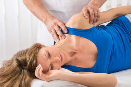 Close-up Of Person Giving Massage To Mature Woman In Spaの写真素材