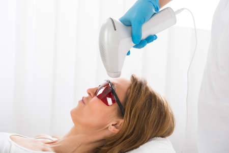 Mature Woman Receiving Laser Hair Removal In Beauty Clinicの写真素材