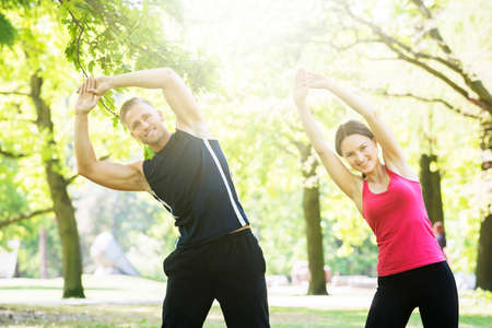 Photo Of Young Couple Exercising Together In Park