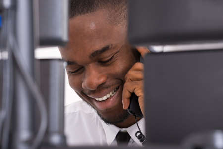 Close-up Of Happy Young Businessman Talking On Telephone