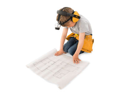Cute Little Boy Looking At Blueprint Isolated On White Backgroundの写真素材