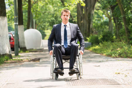 Portrait Of Young Happy Disabled Man On Wheelchairの写真素材