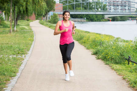 Healthy Young Athletic Woman Running In Morningの写真素材
