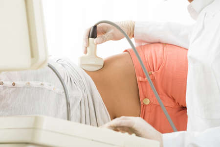 Doctor Is Using Ultrasound Machine To Scan Women's Abdomen In The Clinicの写真素材