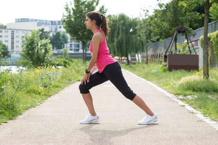 Photo Of Young Fitness Woman Stretching In Park