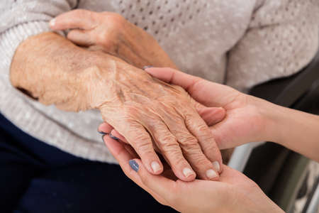 Close-up Of Female Doctor Holding Hand Of Senior Patient