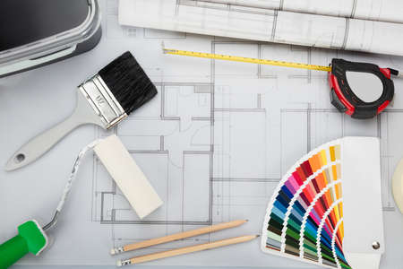 High Angle View Of Blueprint With Tools And Equipment On Desk In Office