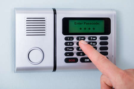 Close-up Of Person's Finger Entering Code In Security System