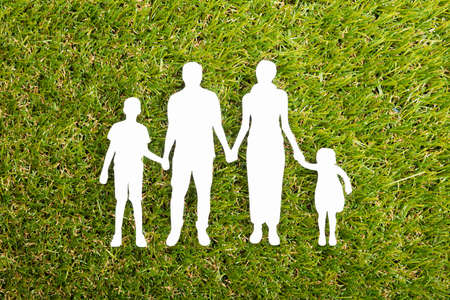 High Angle View Of Family Papercut On Grassの写真素材