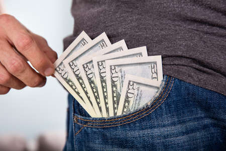 Close-up Of A Man's Hand Holding Fifty Dollar Currency Note From Jean's Pocketの写真素材