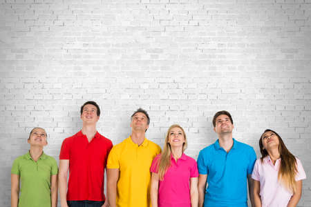 Group Of Diverse Happy People Standing Against A Wall Looking Upの写真素材