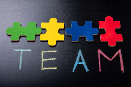 Colorful Jigsaw Puzzle Piece With Text Team On Blackboardの写真素材