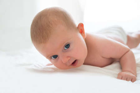 Photo Of An Innocent Baby Playing In Bedの写真素材