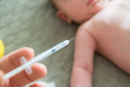 Close-up Of A Doctor Hand Vaccinating Babyの写真素材