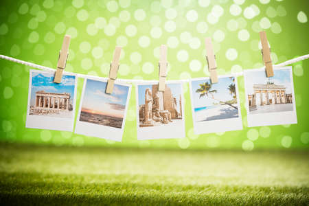 Close-up Of Photos Of Vacation Hanging On Rope With Wooden Clipの写真素材