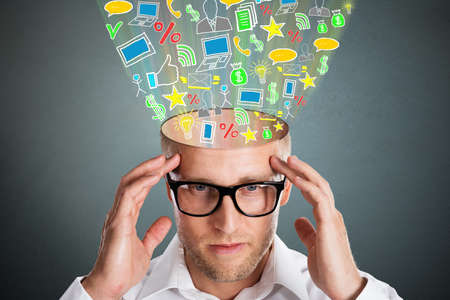 Creative Businessman Ideas With Business Symbols Flying Out Of  His Headの写真素材