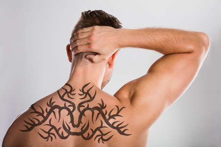 Close-up Of A Man With Tattoo On His Backの写真素材