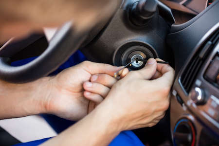 Close-up Of A Person's Hand Inserting Lockpickers Tools In Key Hole