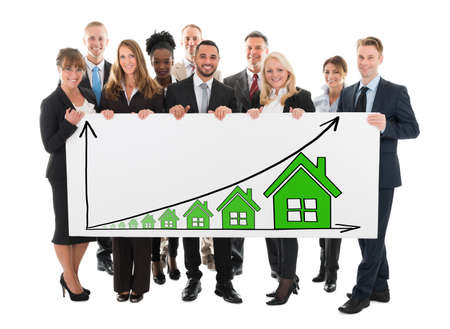 Diverse Business People Holding Billboard Showing House Rising Concept On White Background