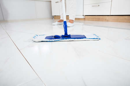 Cleaning Service Woman Mopping The Floor In Kitchen Inside House