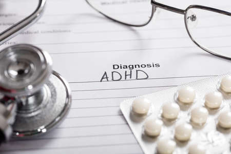 Pills;Glasses And Stethoscope With Text Diagnosis ADHD On Paperの写真素材