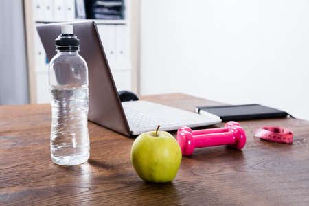 Close-up Of A Fitness Object Near Laptop On Wooden Desk