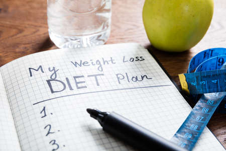 Healthy Living Concept With Diet Plan On Wooden Deskの写真素材
