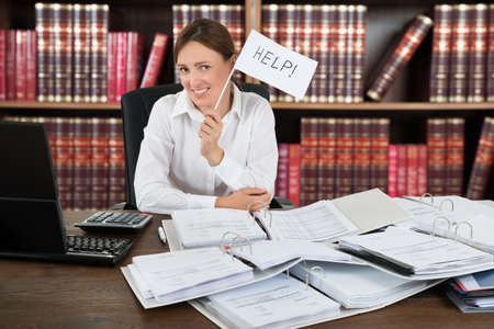 Female Accountant Holding Help Flag With A Pile Of Folders