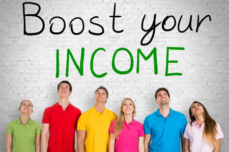 Group Of People Looking Up At Boost Your Income Concept On Wall. Salary Increase Conceptの写真素材