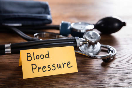 A Sphygmomanometer And Stethoscope With Blood Pressure Concept On Wooden Deskの写真素材