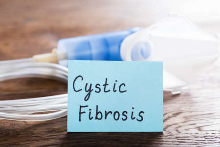 Cystic Fibrosis Concept With Inhaler Mask On Wooden Deskの写真素材