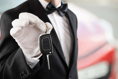 Close-up Of A Valet Boy Holding A Car Key Outside The Carの写真素材