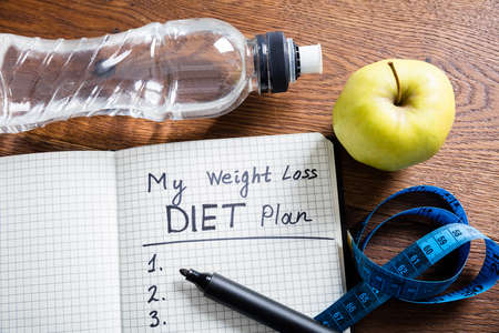 Healthy Living Concept With Diet Plan On Wooden Deskの写真素材