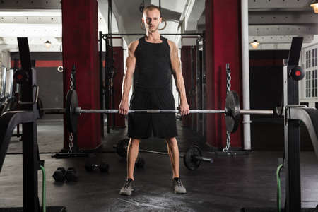 Young Man Doing Barbell Deadlift In The Gym