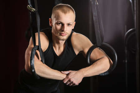 Portrait Of A Young Male Athlete With Gymnastic Rings In The Gymの写真素材