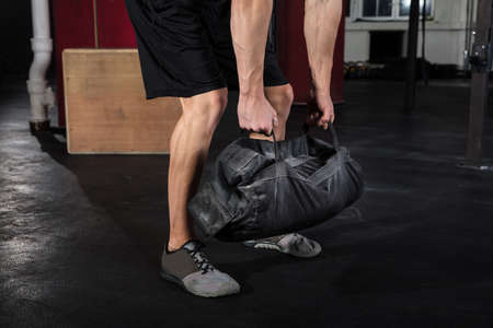 Close-up Of A Young Athlete Man Working With Fitness Bag In The Gym