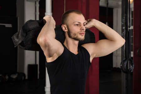 Portrait Of A Young Athlete Man Working With Fitness Bag In The Gym