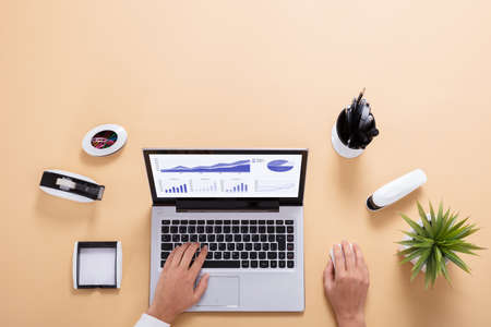 Close-up Of A Businessperson Analyzing Graph On Laptop Screenの写真素材