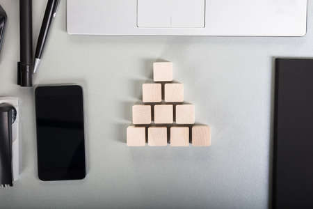 Pyramid Made With Wooden Block On Office Deskの写真素材