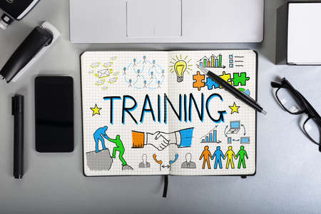 Elevated View Of Training Chart On Notebook Over The Office Desk