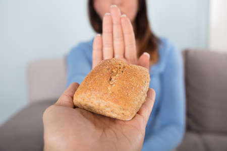 Close-up Photo Of A Woman Rejecting Bread