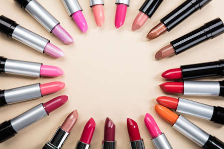 Elevated View Of Lipstick With Colorful Tone Arranged In A Circle On Beige Backgroundの写真素材
