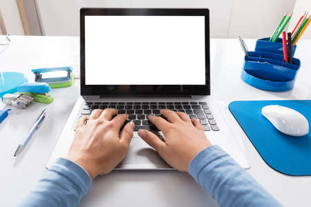 Close-up Of A Woman Working On Laptop At Workplace