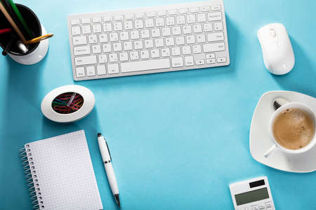 Elevated View Of An Office Desk With Coffee And Suppliesの写真素材