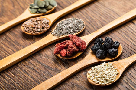 Superfoods: Pumpkin Seeds, Flaxseeds, Chia Seeds, Goji Berries, Quinoa And Aronia Berriesの写真素材